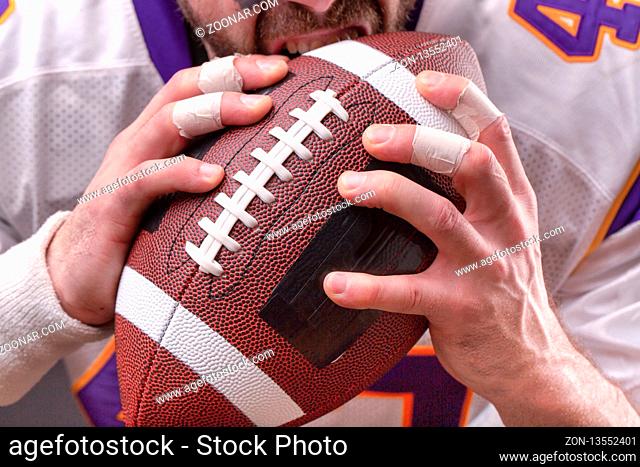Cropped Image Of Sportsmans strong hand Holding American Football Ball