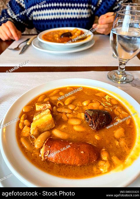Eating fabada asturiana. Asturias, Spain