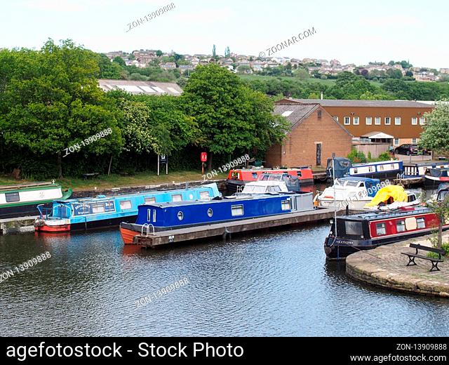 brighouse, west yorkshire, united kingdom: 24 may 2017: a view of brighouse basin boats and moorings on the calder and hebble navigation canal in calderdale...