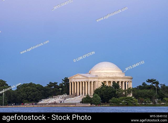 The sky above the Jefferson Memorial turns pink as the sun sets in Washington, D. C