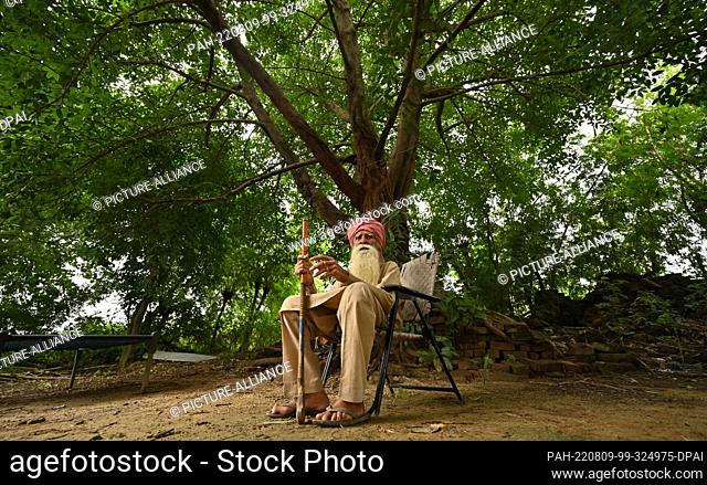 05 August 2022, International, Powt: Pritam Khan sits in front of his house in the village of Powt in the Indian state of Punjab