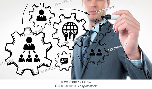Business man interacting with people in cogs graphics against white background
