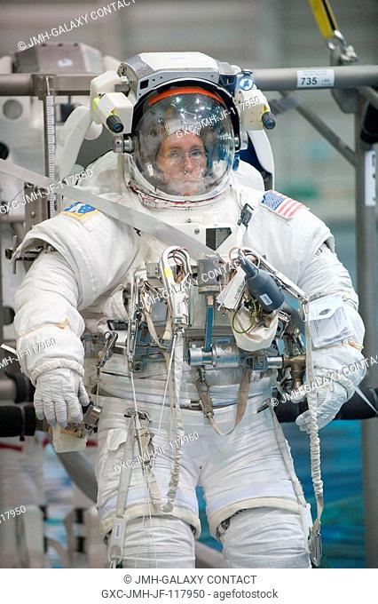 NASA astronaut Sandy Magnus, STS-135 mission specialist, attired in a training version of her Extravehicular Mobility Unit (EMU) spacesuit