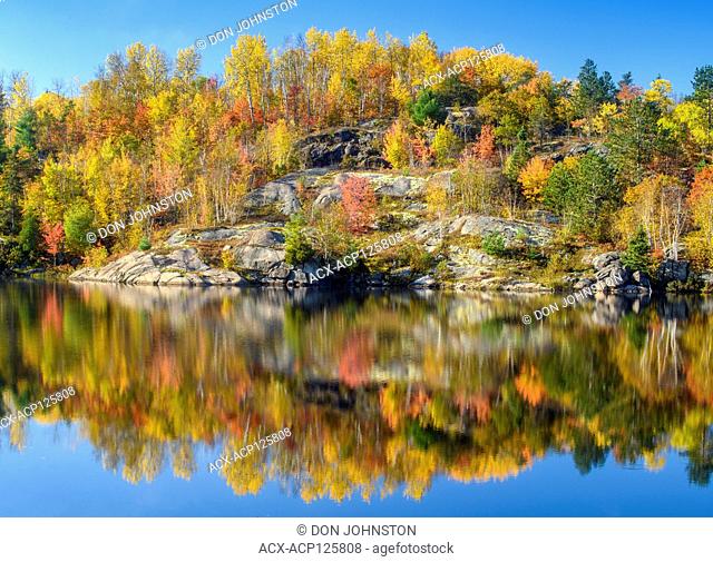 Autumn reflections in Elbow Lake, Greater Sudbury, Ontario, Canada