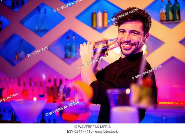 Handsome barkeeper preparing cocktail