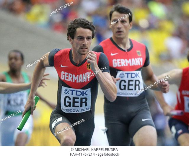 Jonas Plass (L) and Thomas Schneider of Germany compete in the Men's 4x400 Metres Relay heat at the 14th IAAF World Championships in Athletics at Luzhniki...