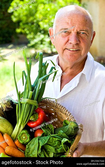 Man Holding Basket of Vegetables