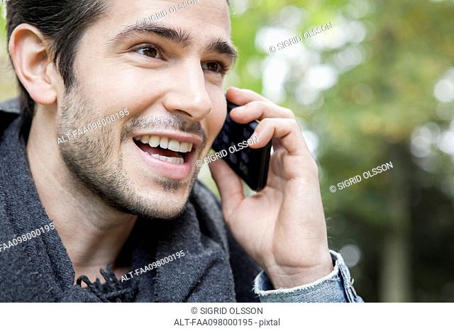 Man outdoors making phone call using cell phone