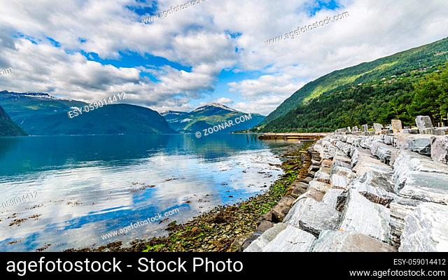 Panoramic view from Sylte or Valldal of Norddalsfjorden in Norway with Valldalen valley, flowers, moutnains and coastline