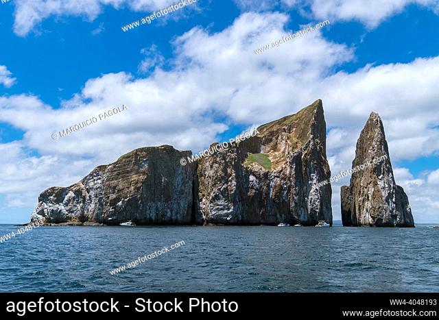 A closeup of Kicker rock island from a boat after a scuba diving experience. The sky is cloudy on a sunny day in San Cristobal Island