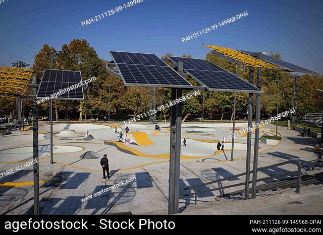 13 November 2021, Armenia, Jerewan: Poles with solar panels stand next to a new skate park in Circular Park on Khaniyan Street behind the ""Yerevan Vernissage""...