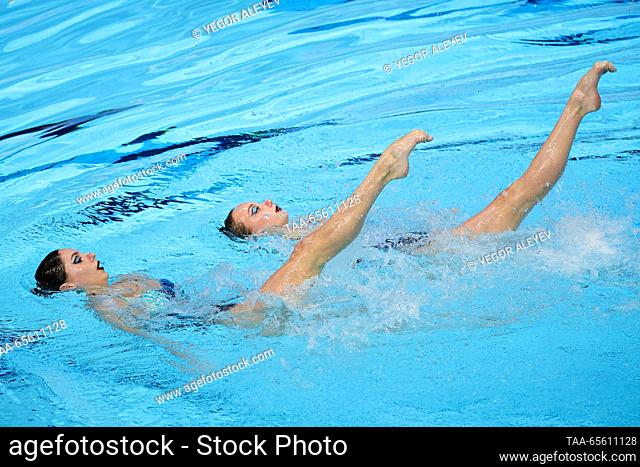 RUSSIA, KAZAN - DECEMBER 10, 2023: Swimmers Aleksandra Bulatova and Anna Andrianova of Russia perform their duet free routine of the junior event during the...