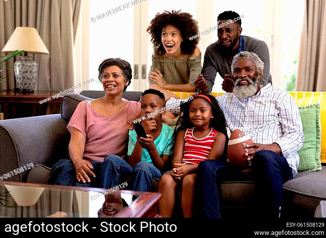 Mixed race family spending time together watching game