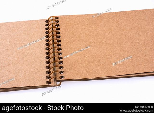 Brown spiral Notebook on a white background