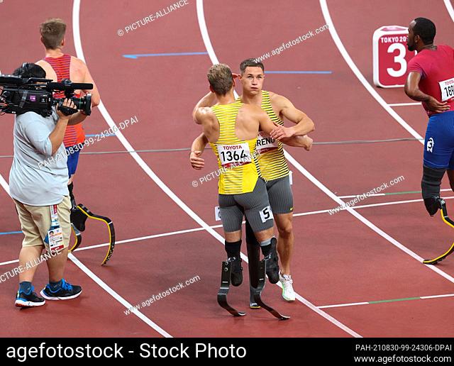 30 August 2021, Japan, Tokio: Paralympics: Athletics, men's 100m, T64, final at the Olympic Stadium. Gold medallist Felix Streng (centre right) and bronze...