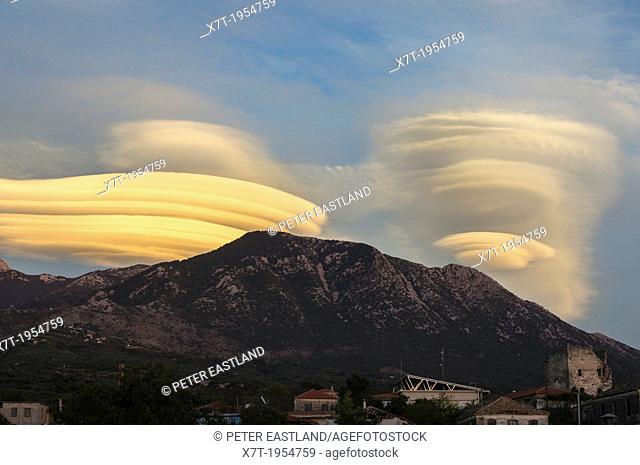Lenticular clouds forming at sunset over the Taygetus mountains, in the Outer Mani, Peloponnese, Greece