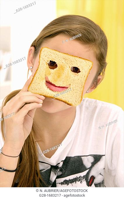 beautiful teenage girl, hiding behind a toast with cut mouth and eyes