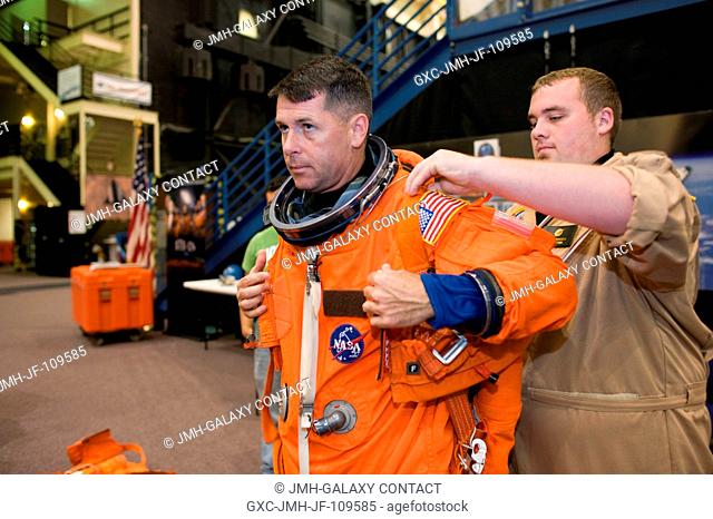 Astronaut Robert S. (Shane) Kimbrough, STS-126 mission specialist, dons a training version of his shuttle launch and entry suit in preparation for a Full...