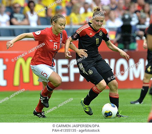 Anja Mittag (R) of Germany fights for the ball with Ingvild Stensland of Norway during the UEFA Women«s EURO 2013 final soccer match between Germany and Norway...