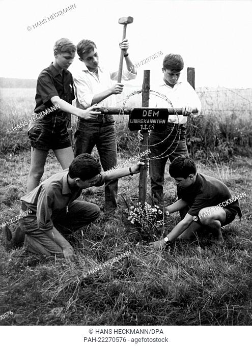 Pupils construct a cross in Schegeiss in the Oberharz in memory of a refugee who was shot down the day before attempting to cross the German-German border