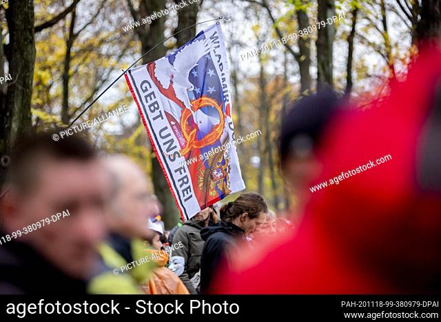 18 November 2020, Berlin: A flag of the ""QAnon"" movement can be seen at a demonstration against the corona restrictions of the German government at the...