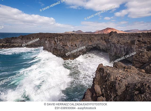 Lanzarote landscape. Los Hervideros coastline, lava caves, cliffs and wavy ocean. No people appears in the scene