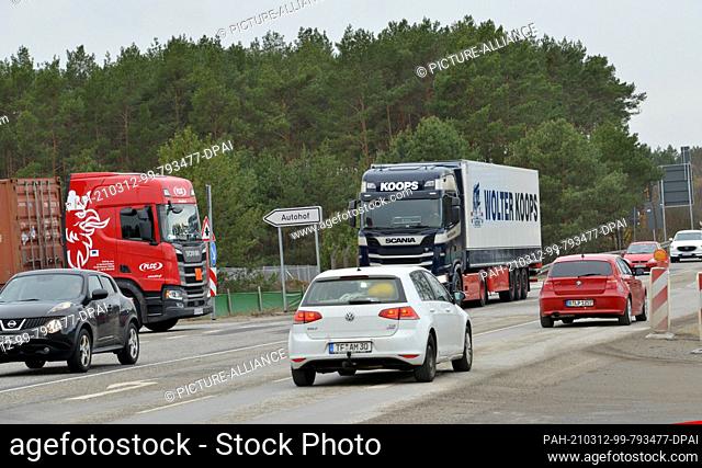 26 February 2021, Brandenburg, Gruenheide: There is a lot of traffic on the L38 road right next to the construction site of the future Tesla Gigafactory...