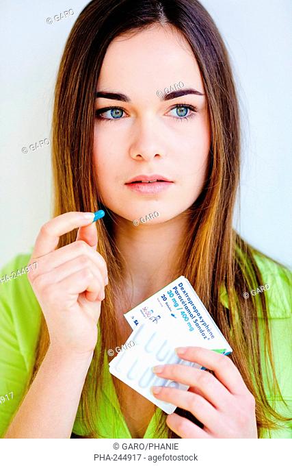 Young woman taking antalgic drug composed of paracetamol and dextropropoxyphene