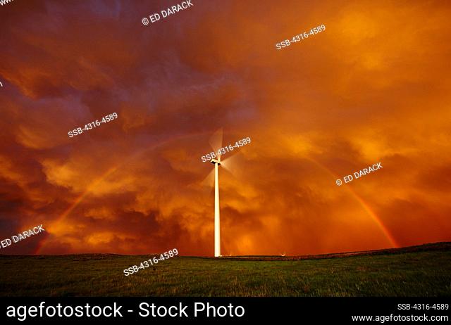 Wind turbine framed by a double rainbow