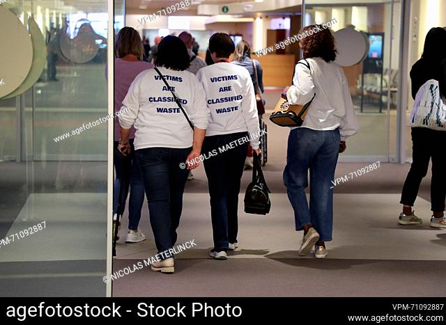 People wearing sweaters with 'Victims are classified waste' urging for better care for victims of terrorism, as they attend a session with the ruling of the...