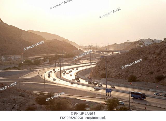 Muscat Expressway backlit from the sun in the afternoon. Muscat, Sultanate of Oman