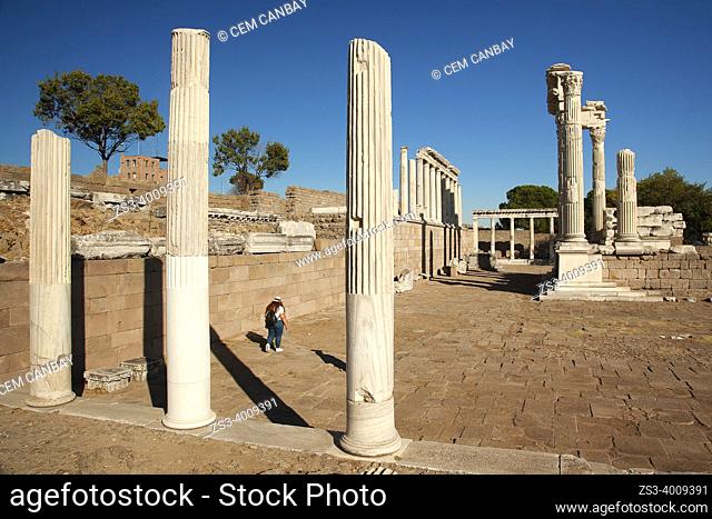 Tourist in front of the marble columns and rests of The Sanctuary of Trajan at Bergama Archaeological site of ancient Pergamon city, Bergama Town