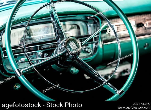 DIEDERSDORF, GERMANY - AUGUST 21, 2021: The dashboard of luxury car Cadillac Series 62 Coupe de Ville, 1953. Close-up. Focus on the foreground