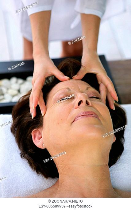 Woman being treated to head massage