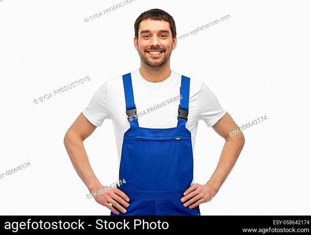 happy smiling male worker or builder in overall