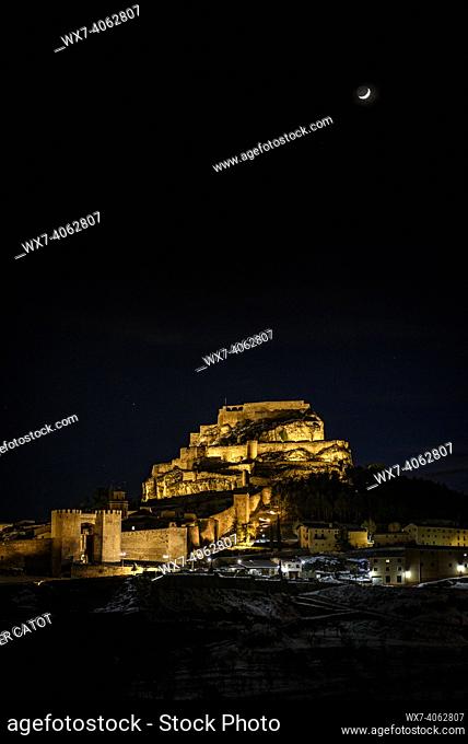 Morella medieval city in a winter night with a crescent Moon, after a snowfall (Castellón province, Valencian Community, Spain)