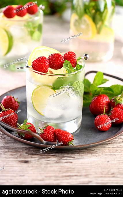 Refreshing organic Mojito cocktail with fresh lime, white rum combined with fresh strawberry and mint. This is the perfect cocktail for summer days