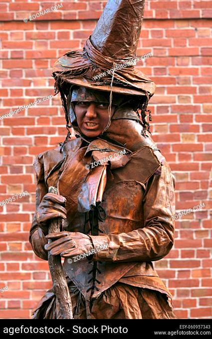 Salem, USA - October 29, 2009: Woman in clothes of Witch on the Halloween Fair in Salem, MA, USA. Witch in brown costume looks at crowd in downtown Salem during...