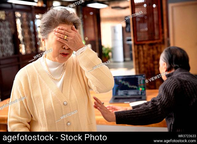 Older couples with a computer check of the stock market