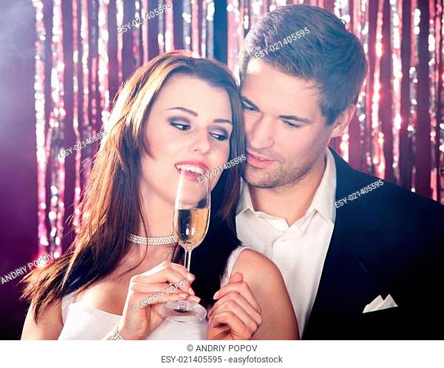 Couple Enjoying Champagne At Nightclub