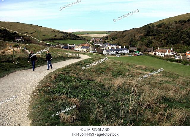 Couple walking on the path from the village of Lulworth Cove, Dorset, England