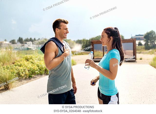 couple with bottle of water after doing sports