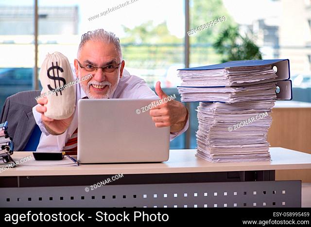 Aged male employee working in the office