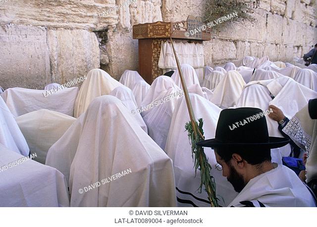 At the Sukkot Jewish religious festival, it is traditional for men to process to the Western Wall or wailing wall in the middle of the city