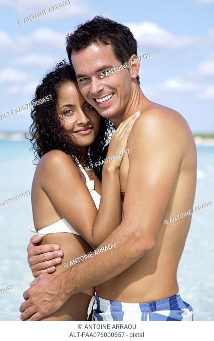 Couple embracing at the beach, portrait