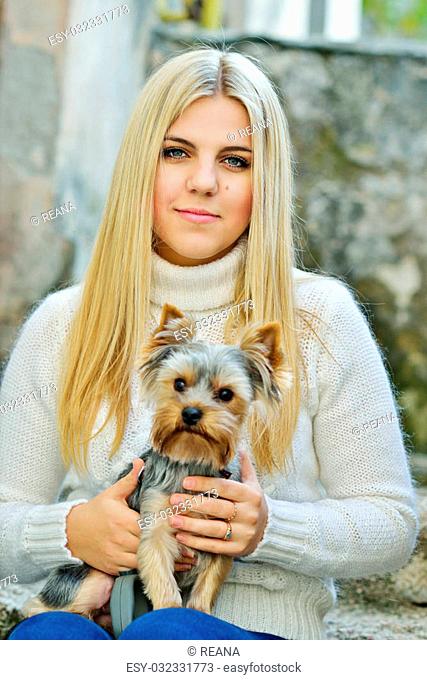teen girl with little dog yorkshire terrier in fall time