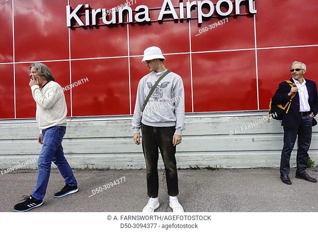 A teenage boy stands at the arrivals area at the Kiruna aiport. Kiruna, Sweden