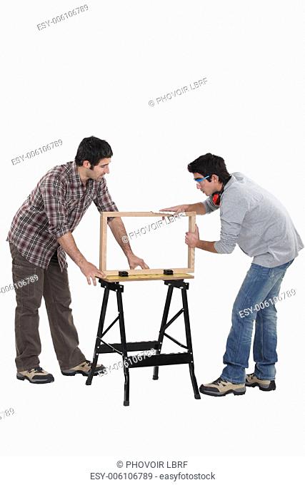 Carpenter and teenage helper