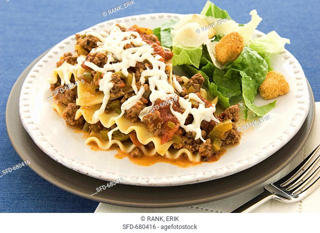 Ground Beef Lasagna and a Side Salad on a White Plate