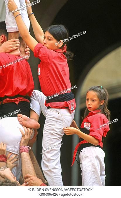 Young ' Castellera' on her way to climb up a human tower. Barcelona. Catalonia. Spain